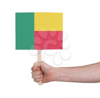 Hand holding small card, isolated on white - Flag of Benin