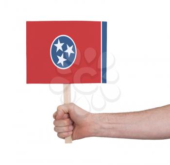 Hand holding small card, isolated on white - Flag of Tennessee