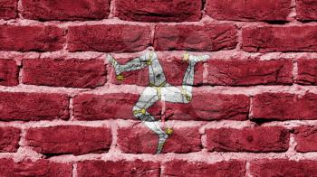 Very old dark red brick wall texture, flag of Isle of Man