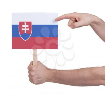 Hand holding small card, isolated on white - Flag of Slovakia