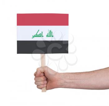 Hand holding small card, isolated on white - Flag of Iraq
