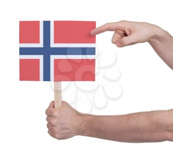 Hand holding small card, isolated on white - Flag of Norway