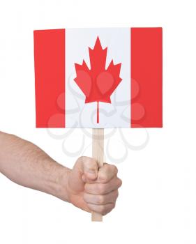 Hand holding small card, isolated on white - Flag of Canada