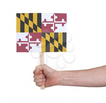 Hand holding small card, isolated on white - Flag of Maryland