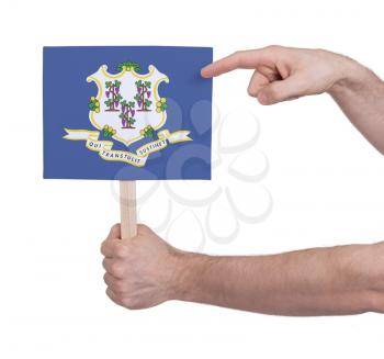 Hand holding small card, isolated on white - Flag of Connecticut