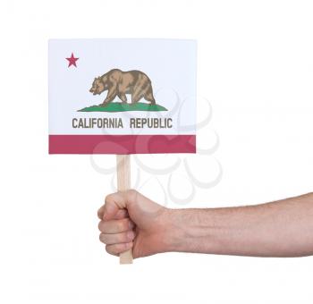 Hand holding small card, isolated on white - Flag of California
