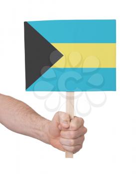 Hand holding small card, isolated on white - Flag of Bahamas