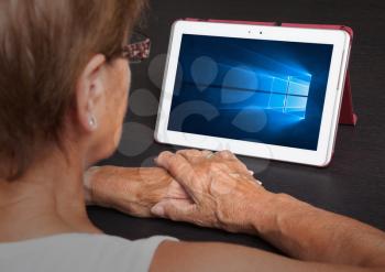 HEERENVEEN, NETHERLANDS, June 6, 2015: Tablet computer with Windows 10 background. Windows 10 is the new version of Windows OS by Microsoft Corporation; it starting July 29, 2015.