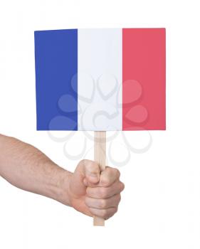 Hand holding small card, isolated on white - Flag of France