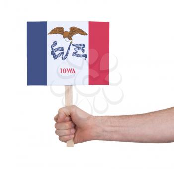 Hand holding small card, isolated on white - Flag of Iowa