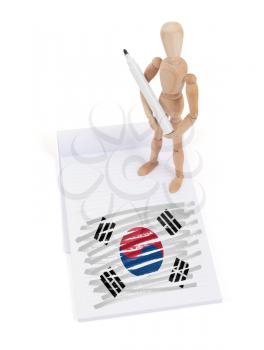 Wooden mannequin made a drawing of a flag -  South Korea
