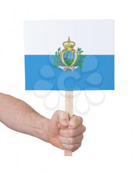 Hand holding small card, isolated on white - Flag of San Marino