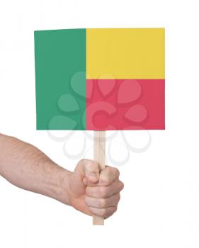 Hand holding small card, isolated on white - Flag of Benin