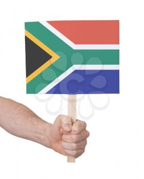 Hand holding small card, isolated on white - Flag of South Africa
