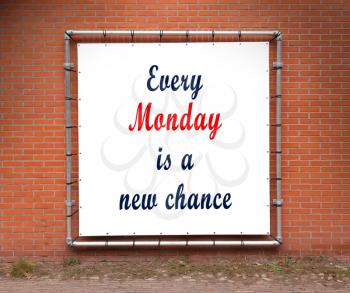 Large banner with inspirational quote on a brick wall - Every monday is a new chance