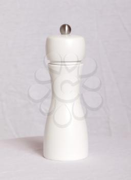 White pepper mill on a white table