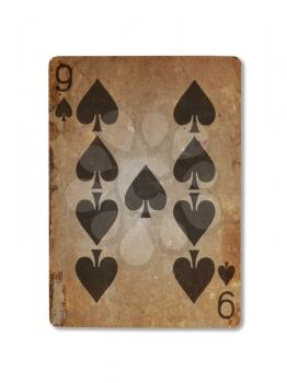Very old playing card isolated on a white background, nine of spades