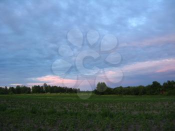 The landscape with beautiful picturesque clouds on the sunset