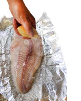 cooking dish with mackerel and lemon juice on the foil