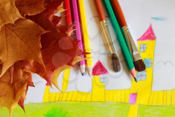Children's drawing of house and yellow autumn leaves
