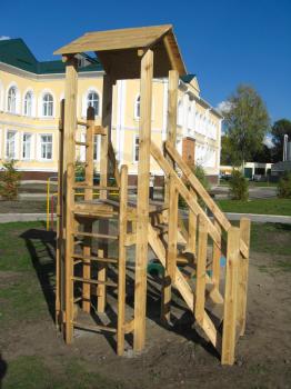 the image of children's play slide near the school