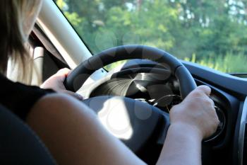 image of young woman driving the car