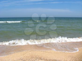 Marine waves on the sand of seacoast