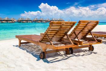 MALDIVES - JUNE 24, 2018: Wooden sunbed on tropical beach in the Maldives at summer day