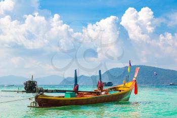 Traditional long tail boat on Coral (Ko He) island near Phuket island, Thailand in a summer day