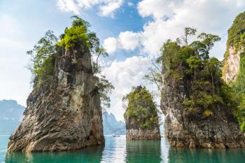 Limenstone rocks at Cheow Lan lake, Ratchaprapha Dam, Khao Sok National Park in Thailand in a summer day