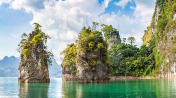 Panorama of Limenstone rocks at Cheow Lan lake, Ratchaprapha Dam, Khao Sok National Park in Thailand in a summer day