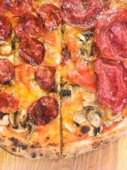 Fresh hot pizza with salami and cheese. Delicious italian traditional fast food