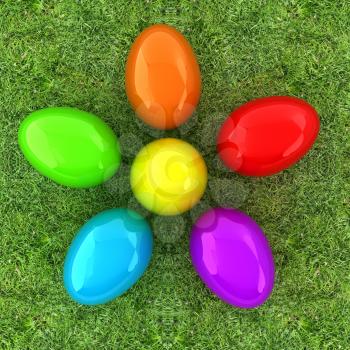 Colored Easter eggs as a flower on a green grass