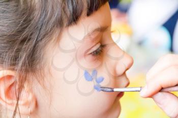 Photo of preschooler with flower on the cheek