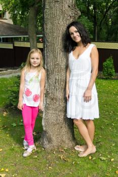 Photo of mother and daughter near tree