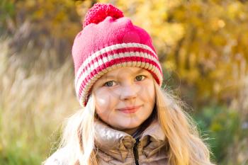 Autumn photo of beautiful girl in red hat