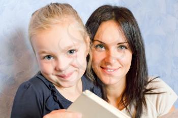 Photo of mother and daughter are reading a book