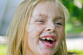 Portrait of cute smiling girl with blond hair