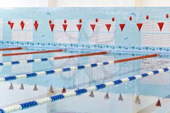 Photo of empty swimming pool with red flags