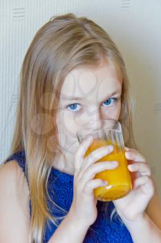 Cute girl with blond long hair drinking beverage