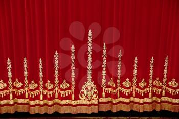 Theatrical red velvet curtain with gold pattern