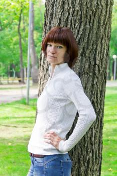 Photo of woman with brown hair near tree