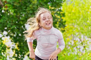 Photo of cute running girl in summer