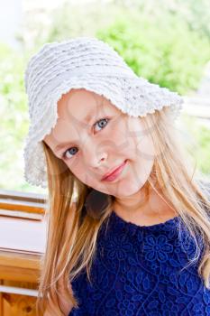 Cute girl with big blue eyes in white hat