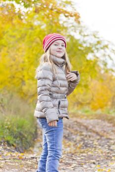 Red Hat girl on walk in autumn