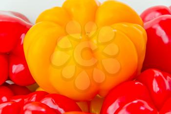 Photo of red and yellow raw pepper on white background