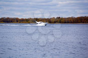 Photo of autumn landscape with motorboat