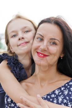 Portrait smiling mother and daughter in summer