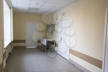 Photo of empty stretcher in hospital corridor