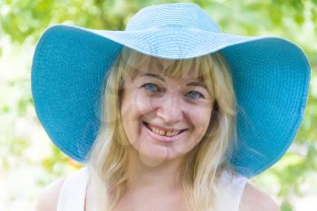 Photo of European blond woman in blue hat